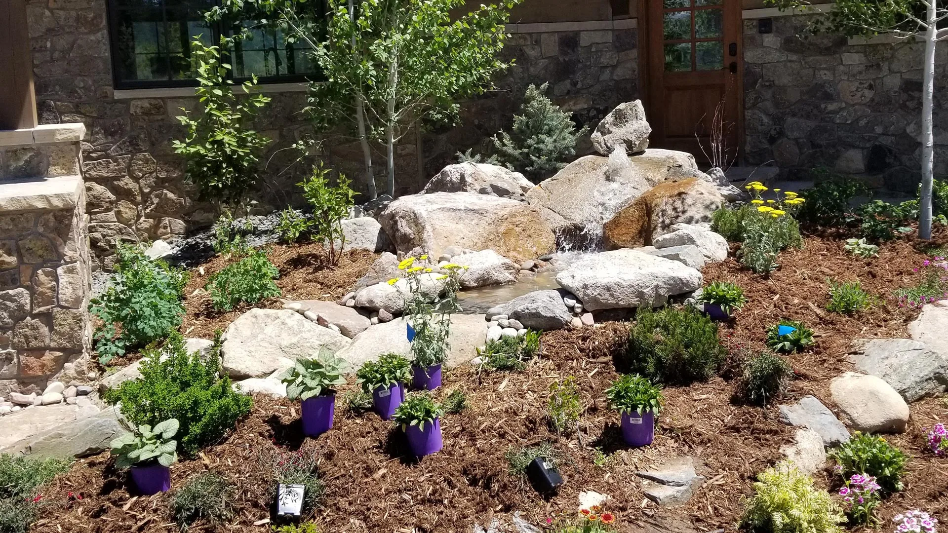 Preparing a landscaping bed for plantings in front of a residential home in Winter Park, CO.