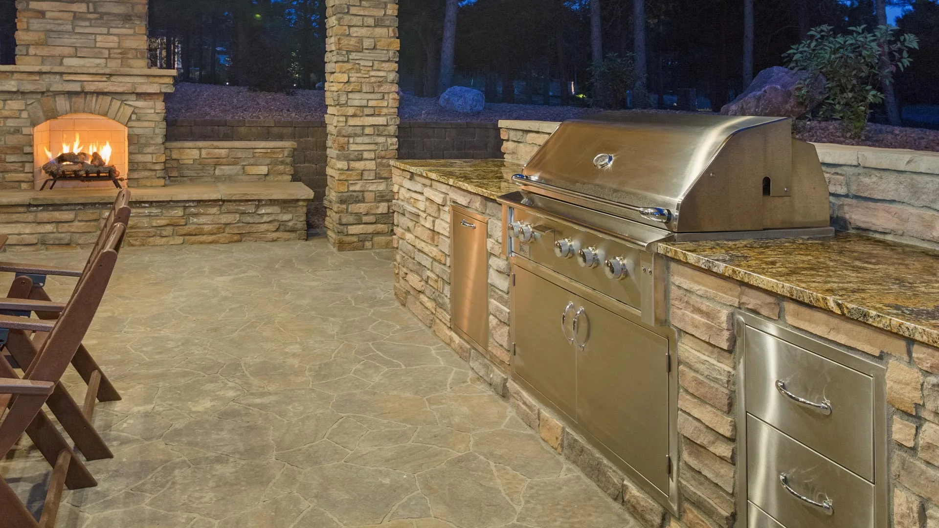 Outdoor kitchen with fireplace built at a home in Fraser, CO.