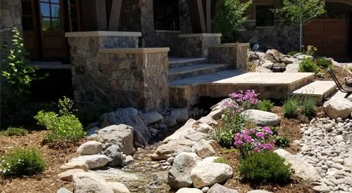 New hardscaping project that includes steps, pathway/walkway, bolder scape, and landscaping at a home in Winter Park, CO.